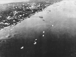 An arial photograph of a shoreland on Harkers Island dotted with small boats in the 1950s.