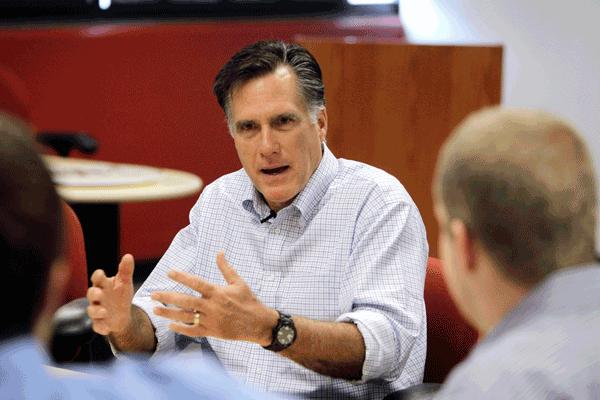 a picture of Mitt Romney conducting a business meeting with two other people.